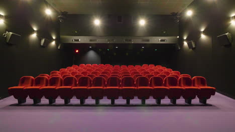 Global-view-of-a-small-empty-movie-theater.-Cinema-room-with-red-seats